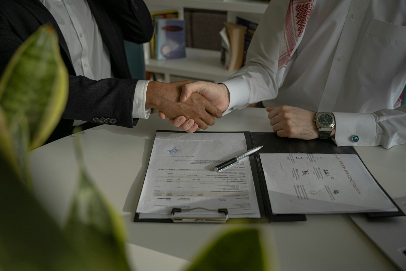 Aperto de mãos sobre contrato assinado